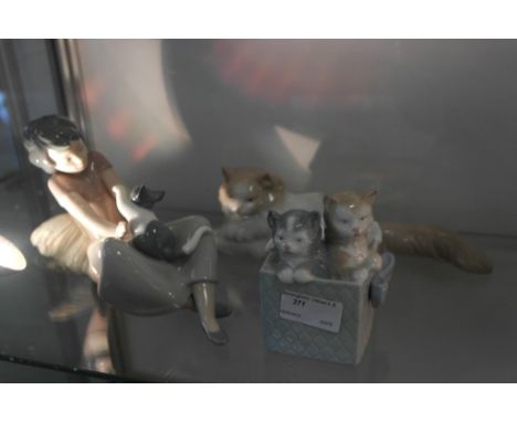 Three Nao figurines of cats