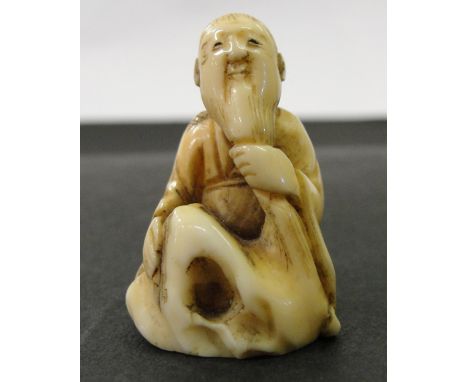 A Japanese Ivory Netsuke:
Meiji period
In the shape of a sitting elderly man holding his long beard.
H 4 cm
