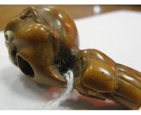 A Japanese Wood Netsuke:
Meiji period
In the shape of a screaming man with ivory-inlaid eyes.
H 5 cm  CONDITION REPORT: No da