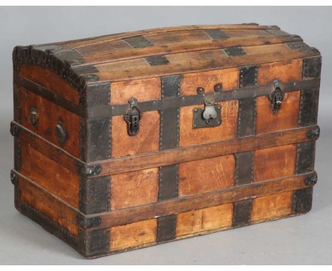 A late 19th century wooden bound dome-topped travelling trunk, height 60cm, width 87cm, depth 50cm.