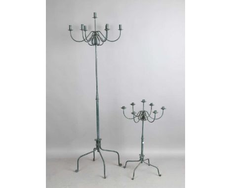 A 20th century green painted wrought iron seven-light candelabrum, height 183cm, together with two smaller candelabra.
