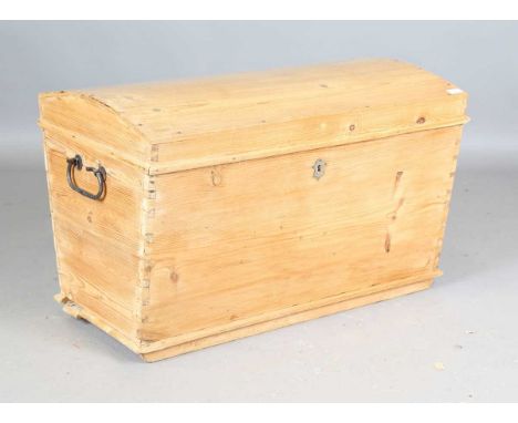 A Victorian pine trunk with a hinged dome lid and iron handles, height 58cm, width 90cm, depth 55cm.