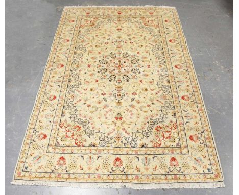 A Mashad carpet, Central Persia, late 20th century, the ivory field with a flowerhead medallion supported by scrolling foliag