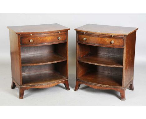 A pair of early 20th century mahogany bowfront bedside tables, each fitted with a slide above an oak-lined drawer and open sh