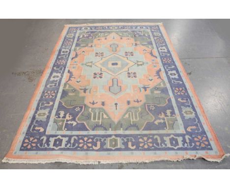 An Indian Dhurrie flatweave carpet, late 20th century, the geometric medallion field within a blue palmette border, 276cm x 1