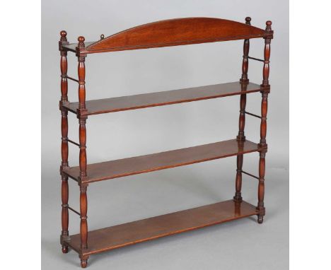 A William IV mahogany wall shelf with arched pediment above three shelves, height 82cm, width 81cm, depth 14.5cm.