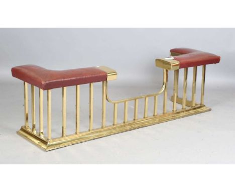A 20th century gilt brass club fender with a brown leather seat, height 50cm, width 172cm, depth 43cm.