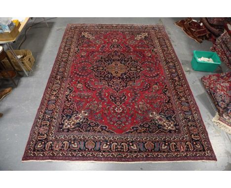 A Mashad carpet, Central Persia, mid-20th century, the pink field with a shaped medallion, within a blue palmette and boteh b