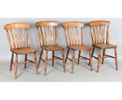 A set of four late Victorian beech and elm comb back kitchen chairs, height 86cm, width 45cm.