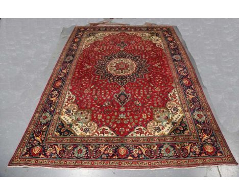 A Tabriz carpet, North-west Persia, mid/late 20th century, the red field with a flowerhead medallion, within ivory spandrels 