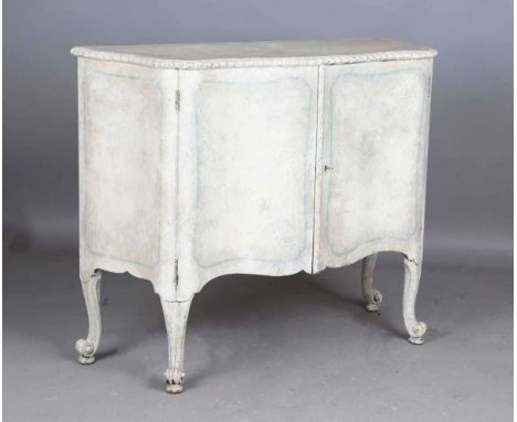 An early 20th century French style painted commode cabinet, the serpentine front fitted with two doors enclosing four sliding