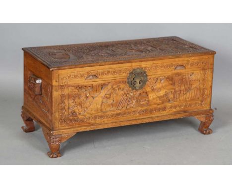 An early 20th century Chinese camphor trunk, carved with figures, the interior with a lift-out tray, height 40cm, width 82cm,