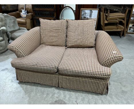 A two seater sofa upholstered in check fabric. 62' wide