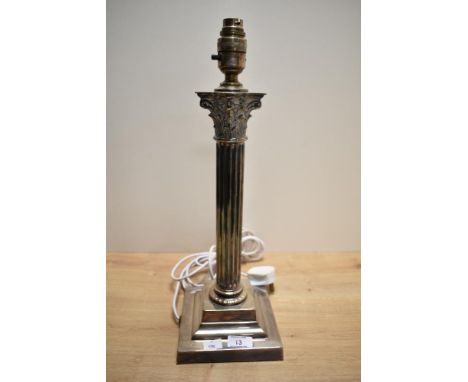 A Victorian silver plated table lamp base, of Corinthian column form and raised on a moulded and stepped base, measuring 47cm