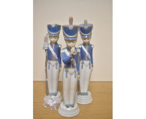 A group of three Lladro porcelain Cadet Soldier figures, comprising soldier with bugle, soldier with rifle and soldier with f