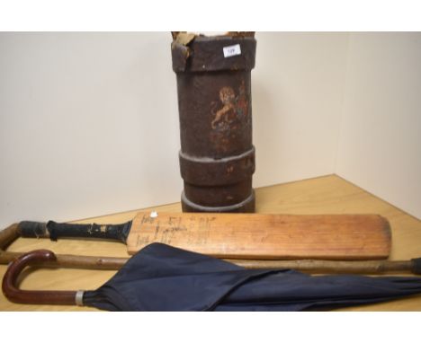 A 19th Century leather armorial cartridge canister with applied Royal Crest, holding cricket bat, walking stick, and umbrella