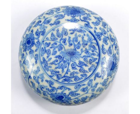 A Chinese porcelain circular paste box overall painted in underglaze blue with flower heads on scroll ground, bearing Kangxi 