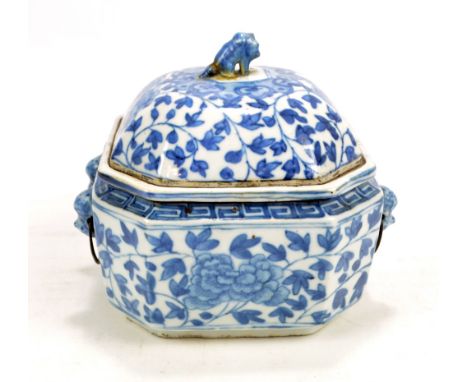 A Chinese porcelain container with cover (finial af) and liner with canted corners and twin mythical beast mask handles, over