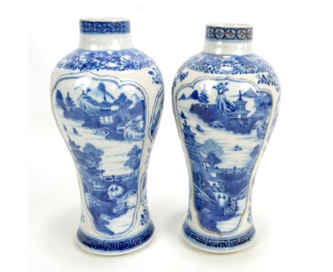 A pair of 19th century Chinese porcelain vases of inverted baluster forms, with raised rims, painted in underglaze blue with 