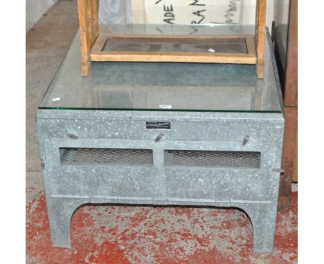 An industrial upcycled incubator by Sydenham Hannaford Ltd converted to a square sectioned coffee table with glass top, glaze