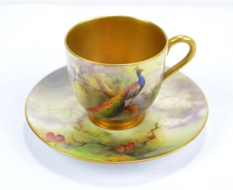 A Royal Worcester cup and saucer painted with pheasant and foliage, both signed R. Austin and with puce marks to bases, cup h