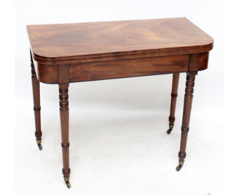 An early 19th century mahogany rounded rectangular foldover card table on ring turned legs with castors, 91 x 91cm when exten