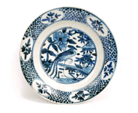 A Chinese porcelain Swatow circular dish painted in underglaze blue with phoenix amongst floral motifs within border of six p