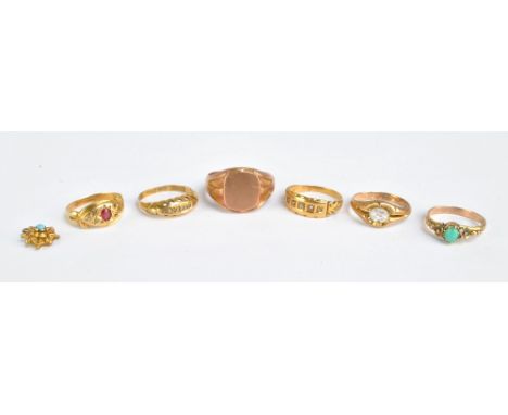 A 9ct yellow gold signet ring with vacant cartouche, and five further rings including an 18ct gold example set with five clea