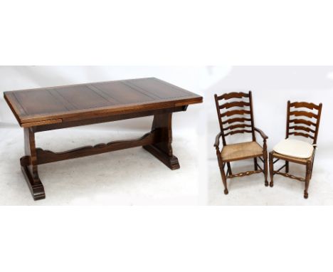 WEBBER; a reproduction oak draw leaf dining table with six wavy ladder back rush seated chairs (4+2) (7).