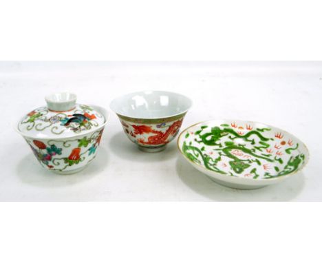 A Chinese porcelain rice bowl and cover painted in enamels with butterflies and floral motifs, with circular seal mark to the