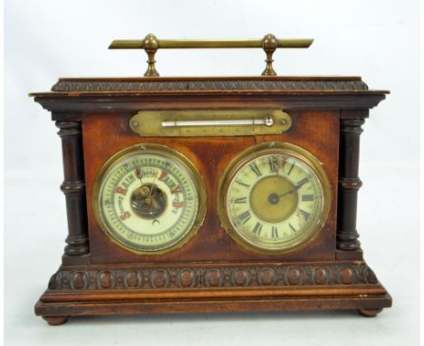 An early 20th century mahogany cased barometer, thermometer and clock, with brass carrying handle above twin circular dials, 