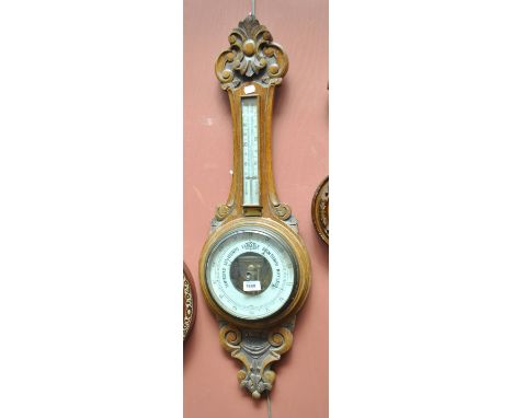 A carved oak aneroid wheel barometer, length 87cm.