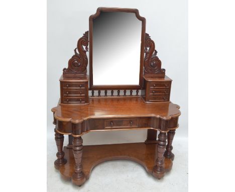 A Victorian mahogany duchess dressing table, the bevelled mirror flanked by pedestals of three drawers above ring turned colu