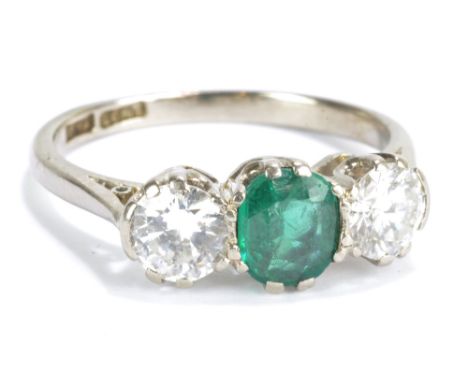 An 18ct white gold three stone ring with two approx 0.50cts diamonds and a similar size green stone, probably paste, approx. 