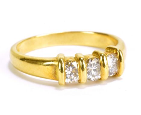 An 18ct yellow gold and diamond three stone ring, size N 1/2, approx 4.6g.