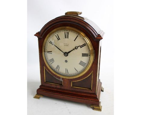 MAPLE; a late 19th century mahogany and brass detailed bracket clock with swing loop carrying handle above circular dial set 