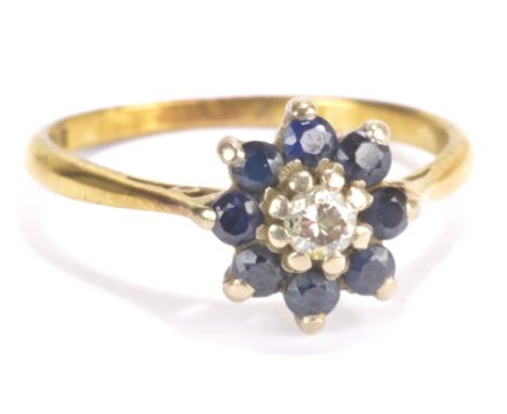 An 18ct yellow and white gold ring, set with a single diamond flanked by eight sapphires in claw setting, size Q, approx 2.9g