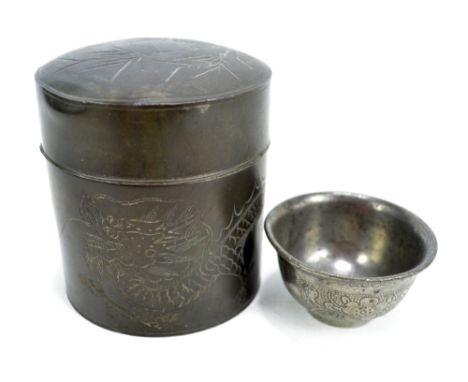 A Chinese Ngan Ki Heung Swatow pewter cylindrical box, incised with chasing dragons to the sides and bamboo to the detachable