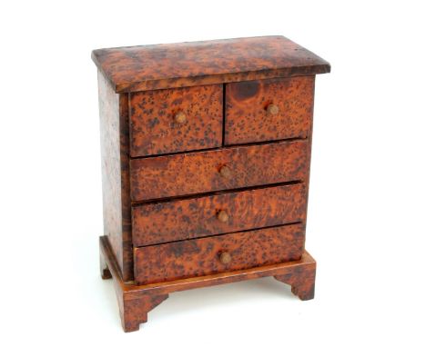A tabletop chest of two over three drawers on bracket feet, 23.5 x 19 x 11cm.