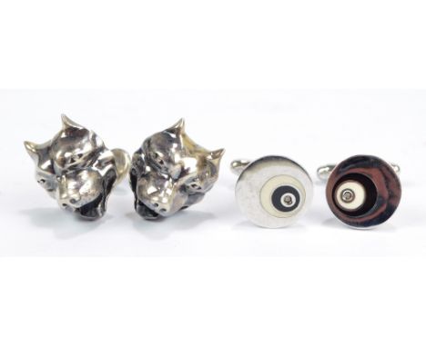 A pair of silver cufflinks modelled as dogs' heads and a further pair of silver cufflinks. CONDITION REPORT: Surface wear, sc