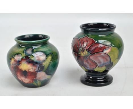 MOORCROFT; a tubeline decorated 'Clematis' pattern footed vase, with remnants of Royal Warrant label to base with impressed m