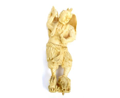 A Japanese Meiji period carved ivory figure of Tengu with wings and beak, holding chisel and mallet, with etched character ma
