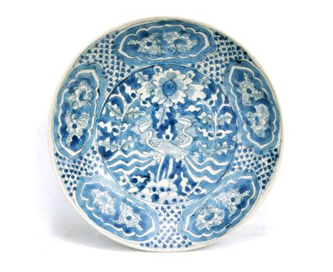 A Chinese porcelain circular shallow bowl, painted in underglaze blue with two phoenix amongst floral and foliate motifs, wit