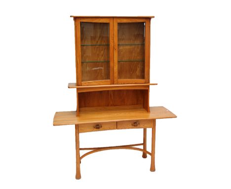 ERCOL; a limited edition Kelmscot cabinet no.66/125 with glazed upper section and two drawers to the base, sold with framed c