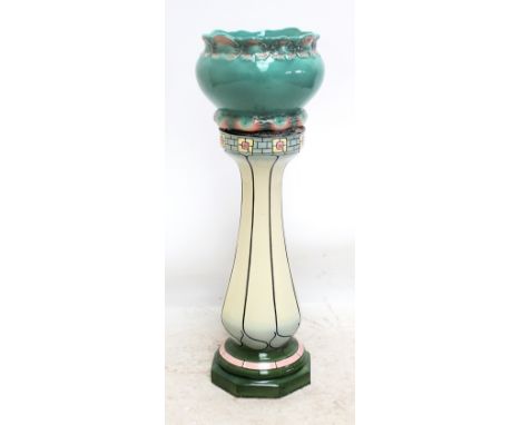A scallop shell decorated ceramic jardinière, diameter of aperture 25cm, on associated Macintosh style baluster stand, total 