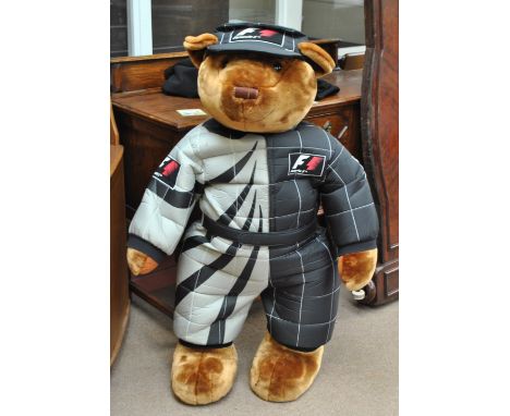 A large Formula 1 teddy bear mascot in branded race suit and cap, height approx 130cm. CONDITION REPORT: Purportedly from a S