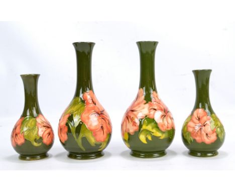 MOORCROFT; two pairs of tubeline decorated 'Hibiscus' pattern bottle vases, all with impressed marks to base, the taller pair