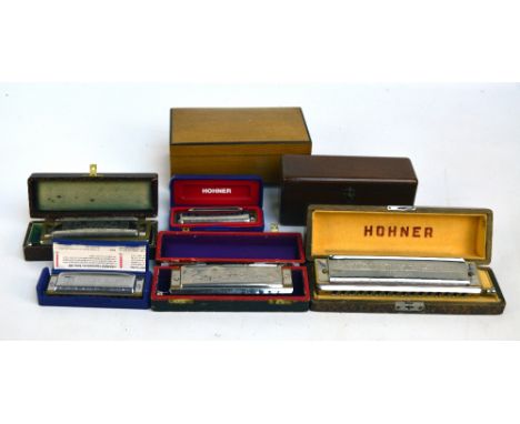 A boxed M Hohner '62 Chromonica', a further smaller example and a 'Blues Harp', and two further mouth organs, also a Paquet m