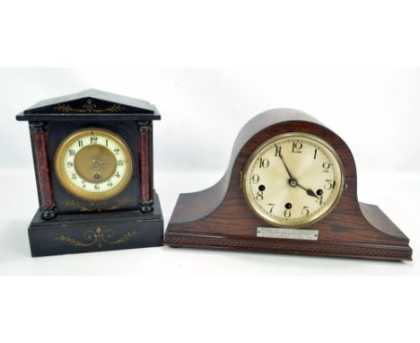 A Victorian black slate mantel clock, height 25cm, also an oak cased Napoleon's hat mantel clock with applied presentation pl