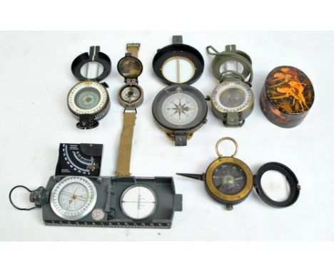 A group of compasses including a military issued RAA compass on canvas strap, no.6B/2953, and a T.G. Co Ltd 1940 MKIII compas